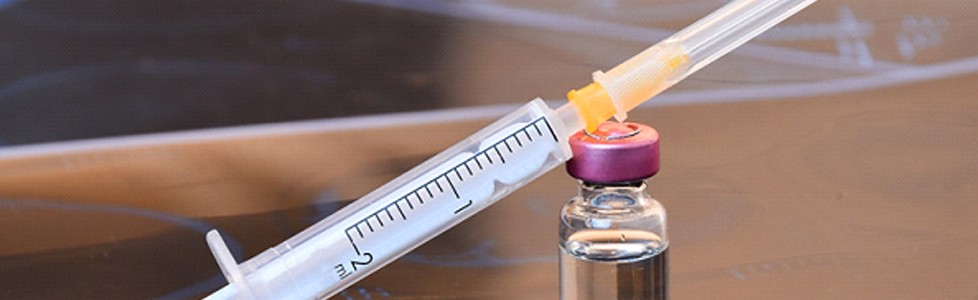 a container of BOTOX with a syringe resting on top of it
